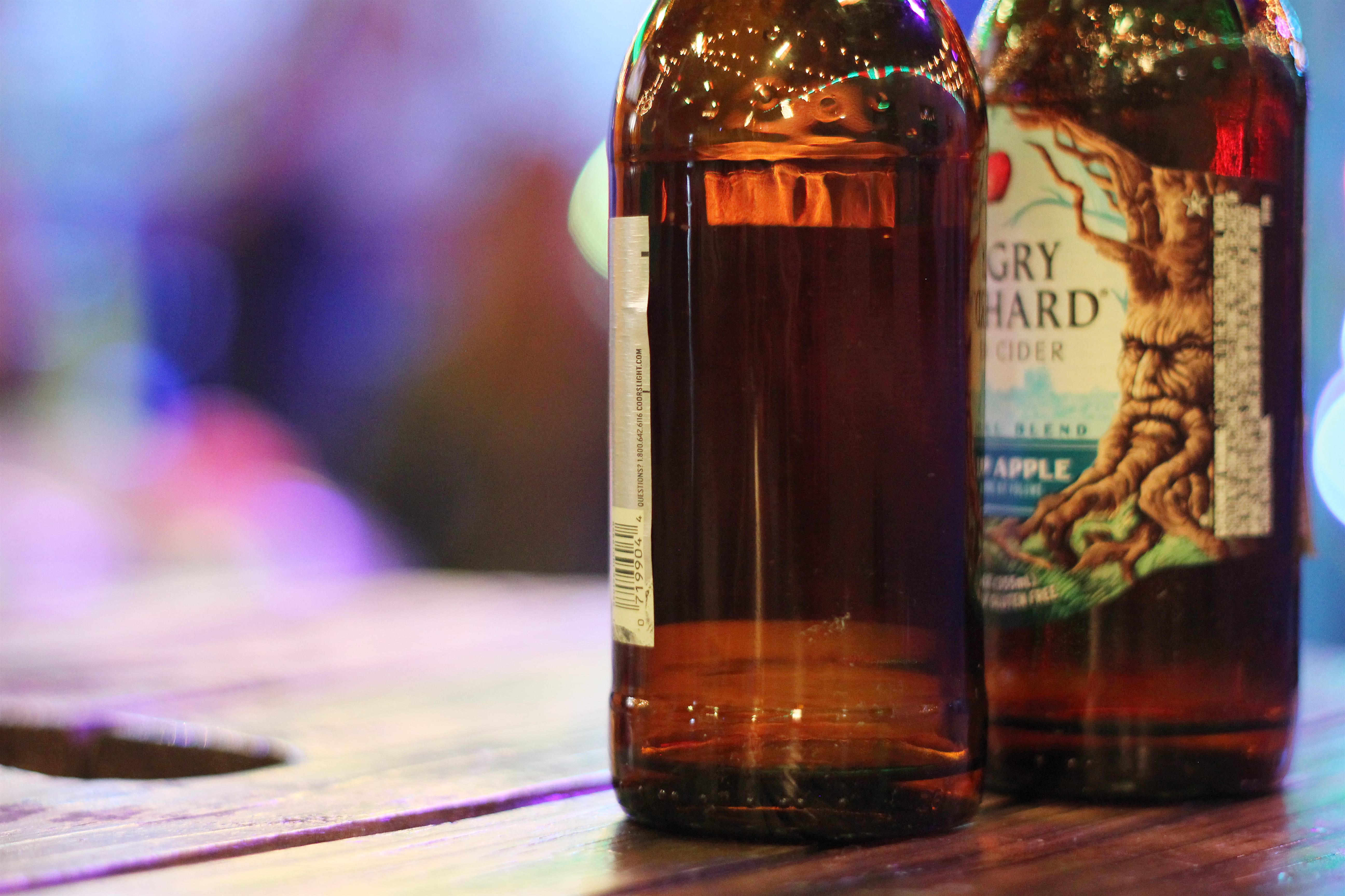 Angry Orchard beer bottles in focus with background blurred